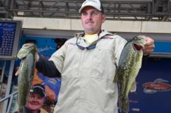Co-angler Cory Leonard of Castalia, N.C., shows off his winning catch at the FLW Tour event on the Potomac River.