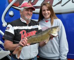Co-angler leader Jimmy Cox holds up a nice Leech Lake walleye with his granddaughter. 