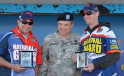 Lt. Col. Jacob Kulzer  presents Sgt. 1st Class Eric Oye and Staff Sgt. Steven Rime with their trophies for winning the National Guard FLW Soldier Appreciation Tournament held on Leech Lake. 