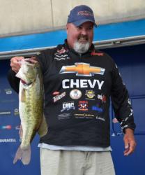 Dion Hibdon holds up a 7-pound, 2-ounce largemouth, the Snickers Big Bass of day one. 