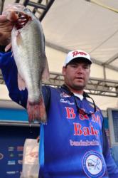 Clent Davis of Montevallo, Ala., holds up part of his first-place catch at the FLW Tour event on Pickwick Lake.