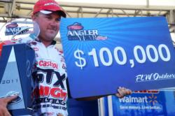 David Dudley of Lynchburg, Va., shows off his 2011 FLW Tour Angler of the Year trophy during the final day of Pickwick Lake action.