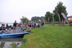 Anglers, volunteers and spectators pause for the national anthem prior to the final day