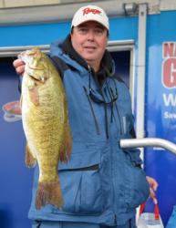 Co-angler leader Greg Scott holds up his biggest bass from day one on Lake Champlain.