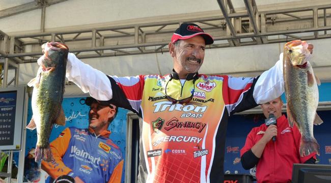 Pro leader Paul Elias holds up his two biggest bass from day two on Lake Guntersville. 