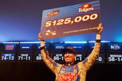 Brent Ehrler of Redlands, Calif., shows off his first-place check after winning the FLW Tour event on Lake Hartwell.