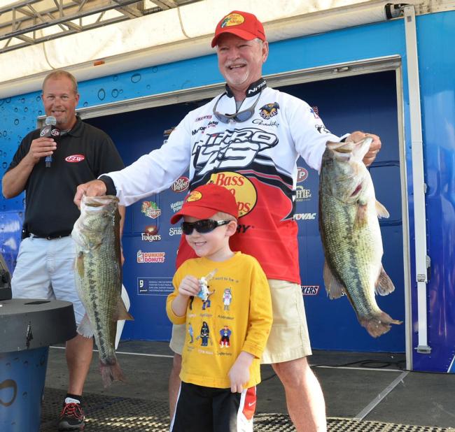 Second-place pro Stacey King holds up two giant largemouths with his grandson Wit. 