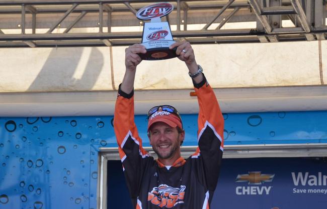 Co-angler Patrick Bone holds up his trophy for winning the FLW Tour event on Table Rock Lake.
