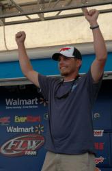 Tyler Webb of Arnett, W. Va., raises his hands in the air in victory shortly after winning the Co-angler Division at the 2012 TBF National Championship at Bull Shoals Lake.