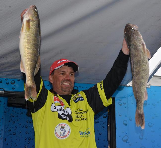 Third-place pro Brett King holds up two nice Mississippi River walleyes.