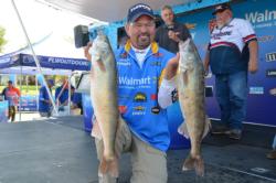 Walmart pro Dean Arnoldussen of Appleton, Wis., shows off two nice fish from his 37 pound, 14 ounce limit on day 1. 