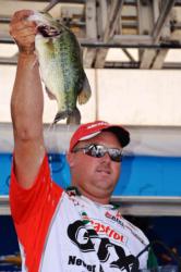 Castrol pro David Dudley of Lynchburg, Va., holds up his third-place catch during the FLW Tour finals on the Potomac River.