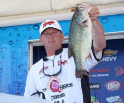 Co-angler Daniel Ferguson shows off one of the fish in his leading sack.