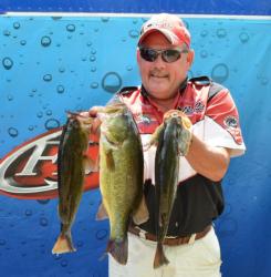 Fifth-place pro Kevin Johnson holds up his three-fish limit Friday. 