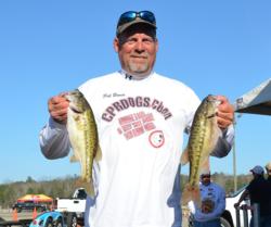 Second-place co-angler Rick Bowen holds up a pair of Smith Lake spotted bass.