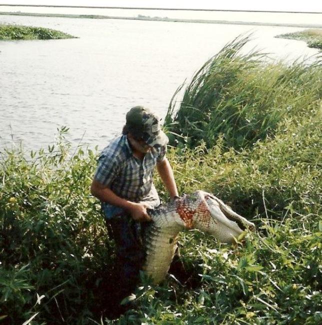 A younger Troy Broussard literally wrestles an alligator onto shore.