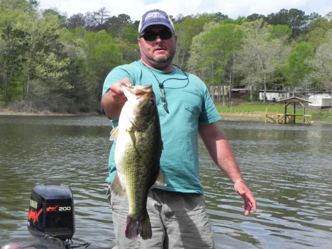 Troy Broussard proudly displays his other main passion in life - bass fishing.