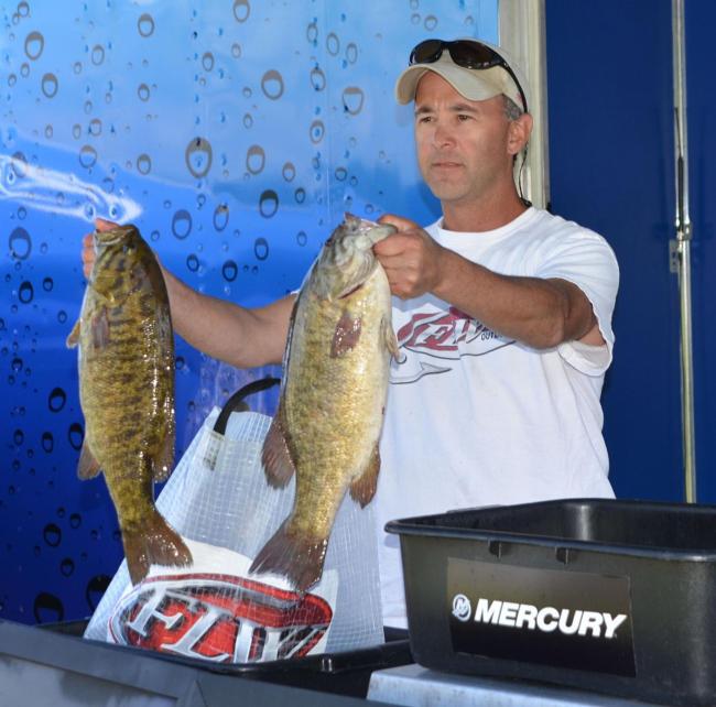 Second-place co-angler Jim Hippensteel holds up two nice smallmouth bass.