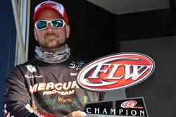 Ryan Bauman of Fleetwood, Pa., proudly displays his first-place trophy after capturing the co-angler title on the Chesapeake Bay.