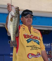 Co-angler leader Greg Knick holds up his biggest bass from day one on Lake Okeechobee.