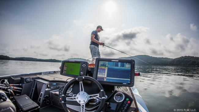 Martin eyes his bow graph as he fishes a school. He runs a Lowrance HDS-12 as his primary fish-finding unit at the console with a Humminbird to run LakeMaster maps next to it. 